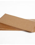 A stack of beige, rectangular sticky plates designed for use in a Deltatrap pheromone dispenser for pest control.