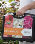 Man holding mini-airbug case, 