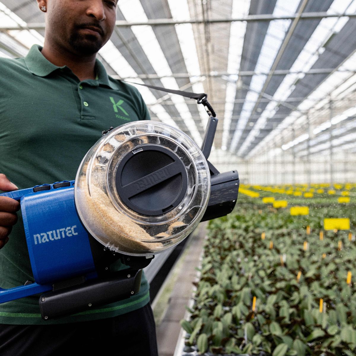 Person in greenhouse using the Natutec Airobreez on plants