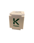A white plastic magnifying lens with a scale, featuring the brand name 'Koppert' on the lens.